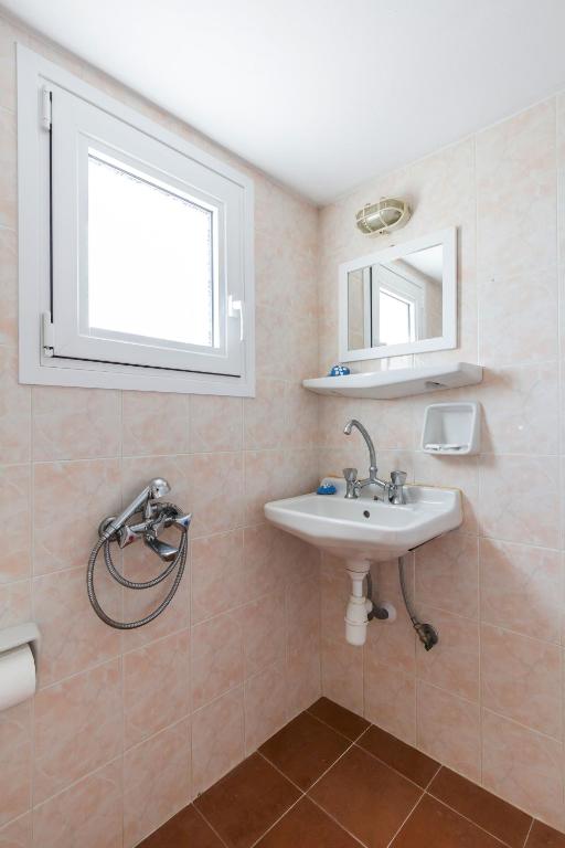 a bathroom with a sink and a mirror at Villa Thea in Panormos Skopelos