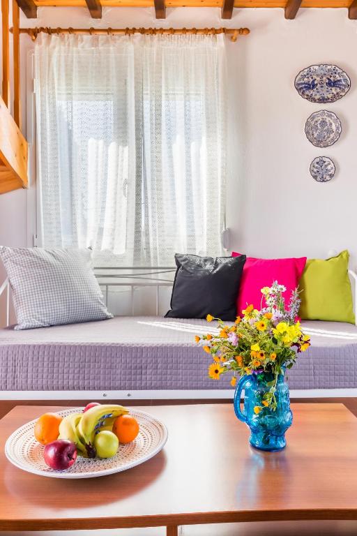 a living room with a table with a plate of fruit at Villa Thea in Panormos Skopelos