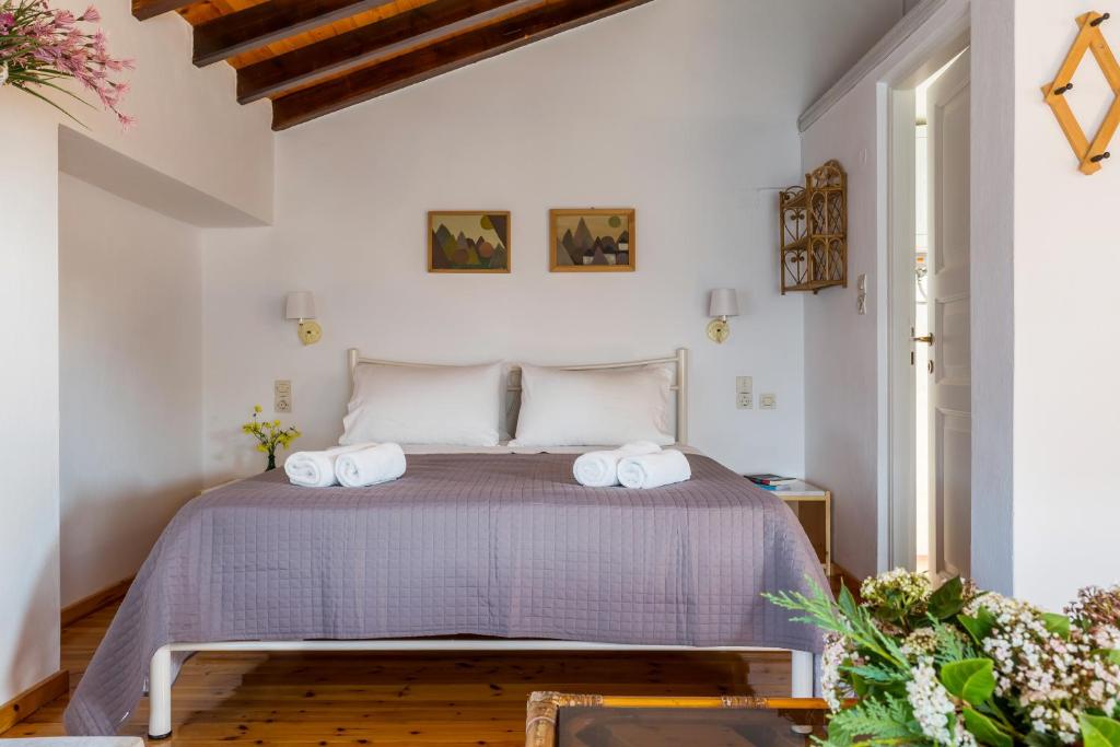 a bedroom with a bed with two towels on it at Villa Thea in Panormos Skopelos