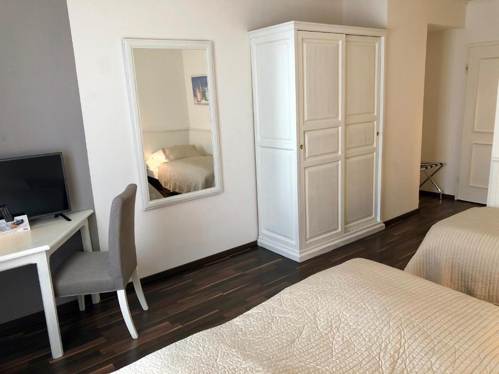 Postel nebo postele na pokoji v ubytování Hotel Toskana