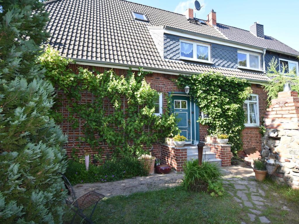 ボルテンハーゲンにあるLuxurious Apartment in Ostseebad Boltenhagen with Gardenの青い扉のあるレンガ造りの家