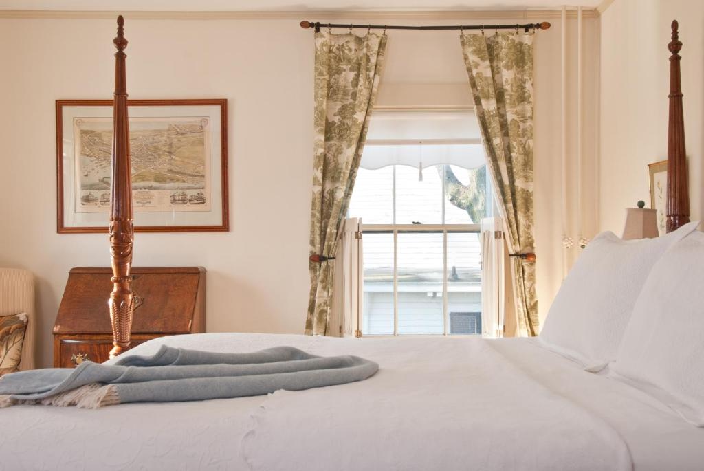 a bedroom with a bed with a window at Marshall Slocum Inn in Newport