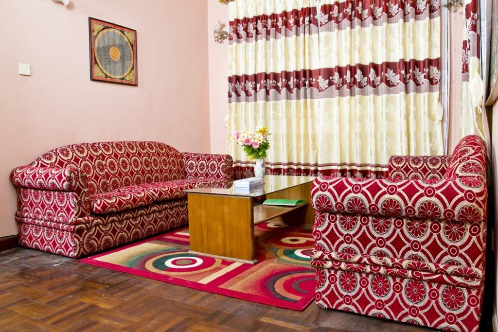 a living room with a couch and a table at Swagat homestay in Kathmandu