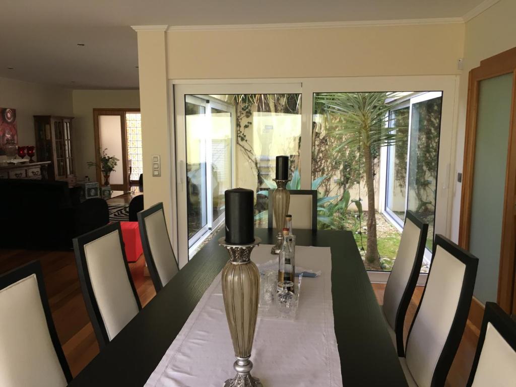 a dining room with a table with a vase on it at Terra Mar in Ponta Delgada