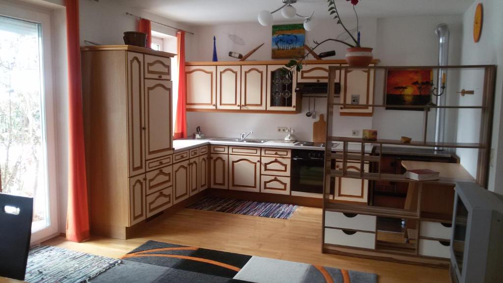 a kitchen with wooden cabinets and a sink at Pura Vida in Velden am Wörthersee