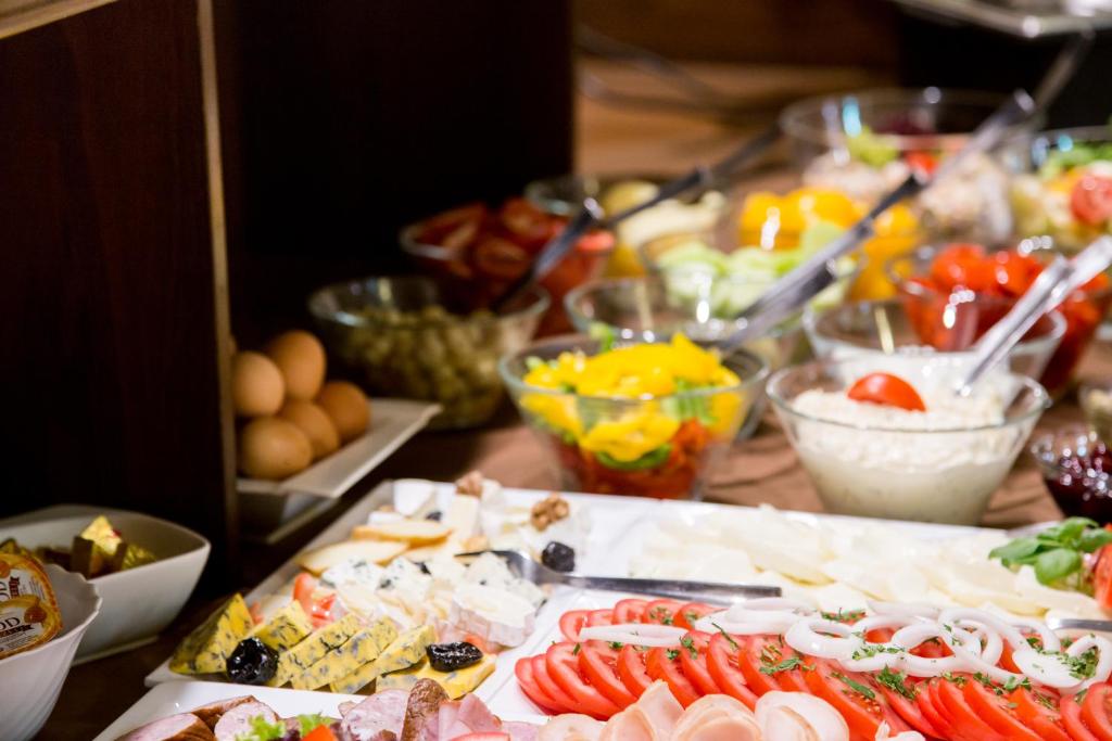 a table topped with lots of different types of food at Hotel Maksymilian in Krakow