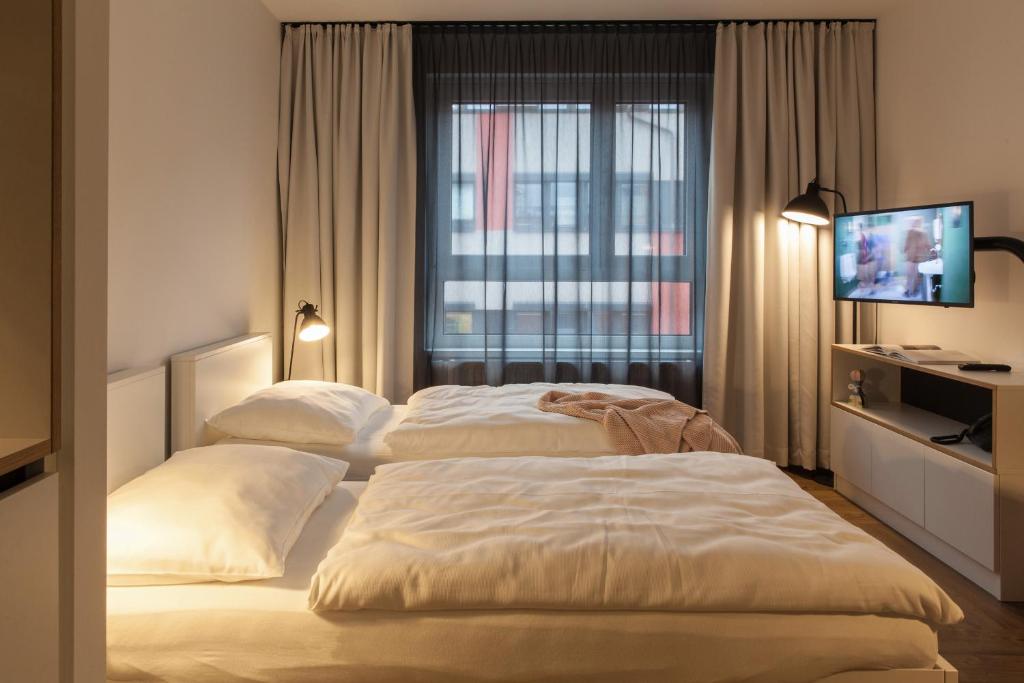 Postel nebo postele na pokoji v ubytování smartments Wien Hauptbahnhof - Serviced Apartments