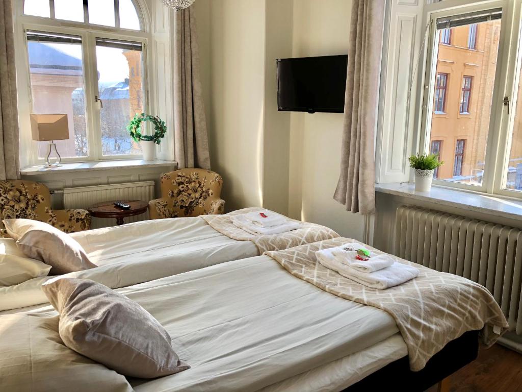 Postel nebo postele na pokoji v ubytování Järnvägshotellet