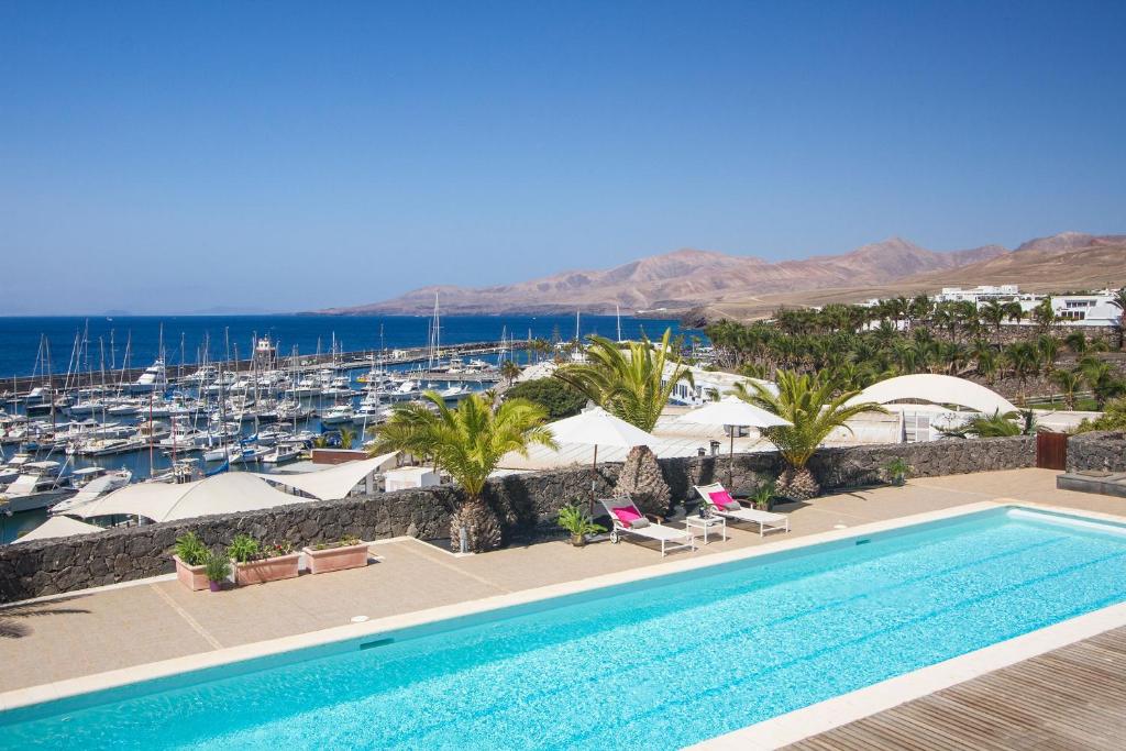 a swimming pool with a view of a marina at Villa Mila in Puerto Calero