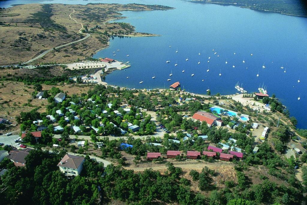 an aerial view of a small island with boats in the water at Camping de Cervera de Buitrago in Cervera de Buitrago