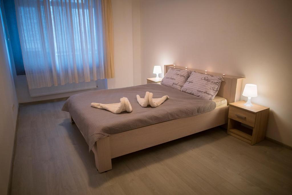 a bedroom with a bed with two towels on it at Vitan Residence in Bucharest