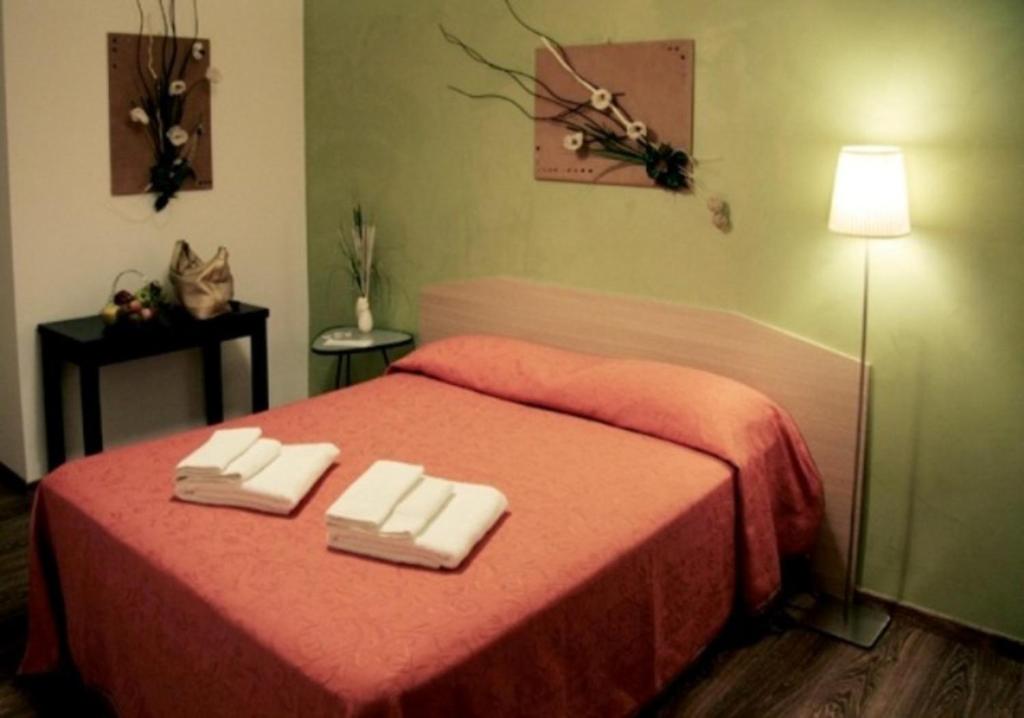 Un pat sau paturi într-o cameră la B&B Oltrelmar