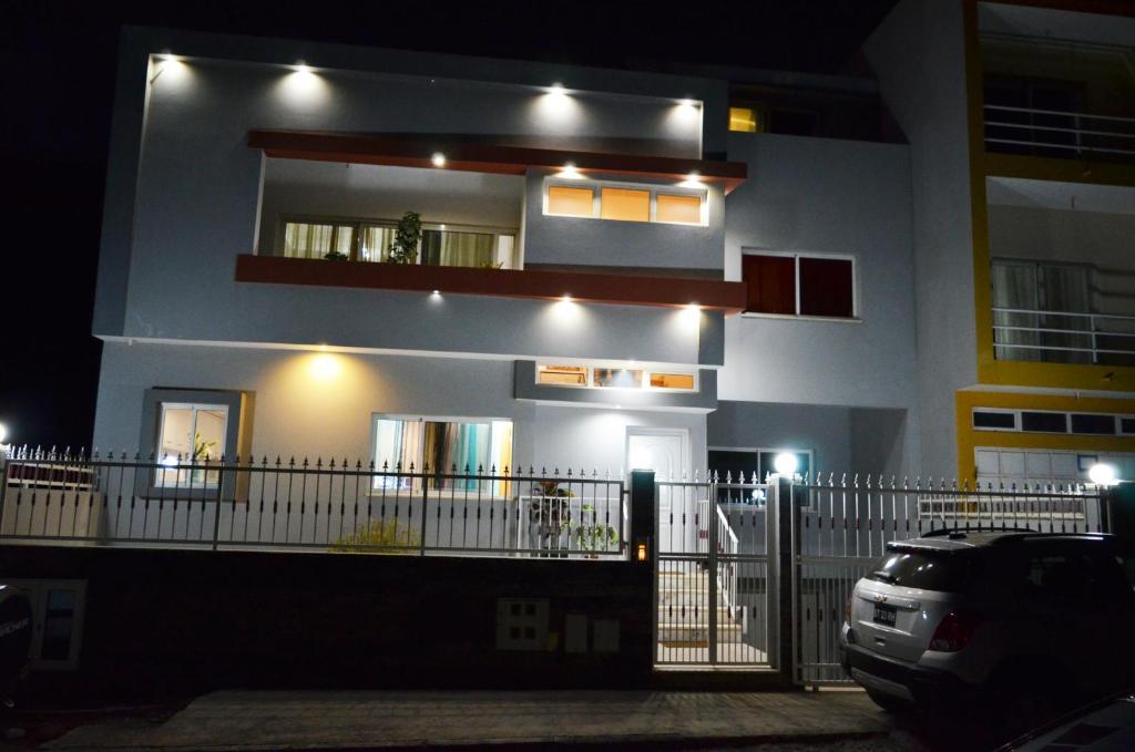 a building with a balcony with lights on it at House Gonçalves in Praia