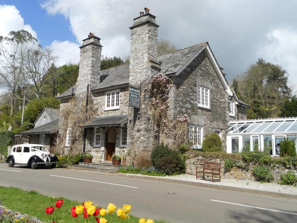 a stone house with a car parked in front of it at Polraen Country House Hotel in Looe
