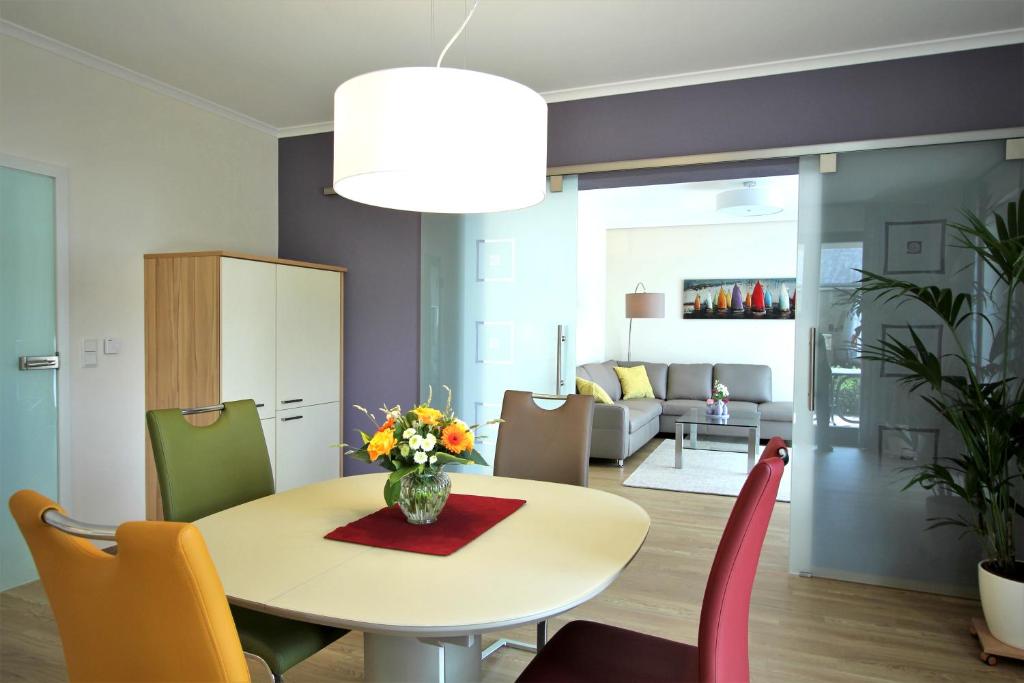 een eetkamer en een woonkamer met een tafel en stoelen bij Auf dem Blumenhof in Heringsdorf