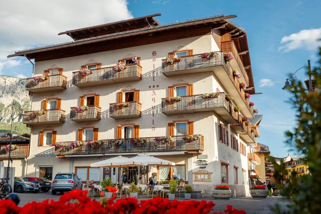a hotel room with a large building at Hotel Aquila in Cortina dʼAmpezzo