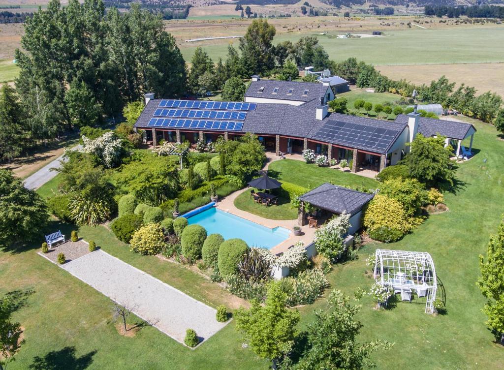 an aerial view of a house with solar panels on it at Lime Tree Lodge in Wanaka