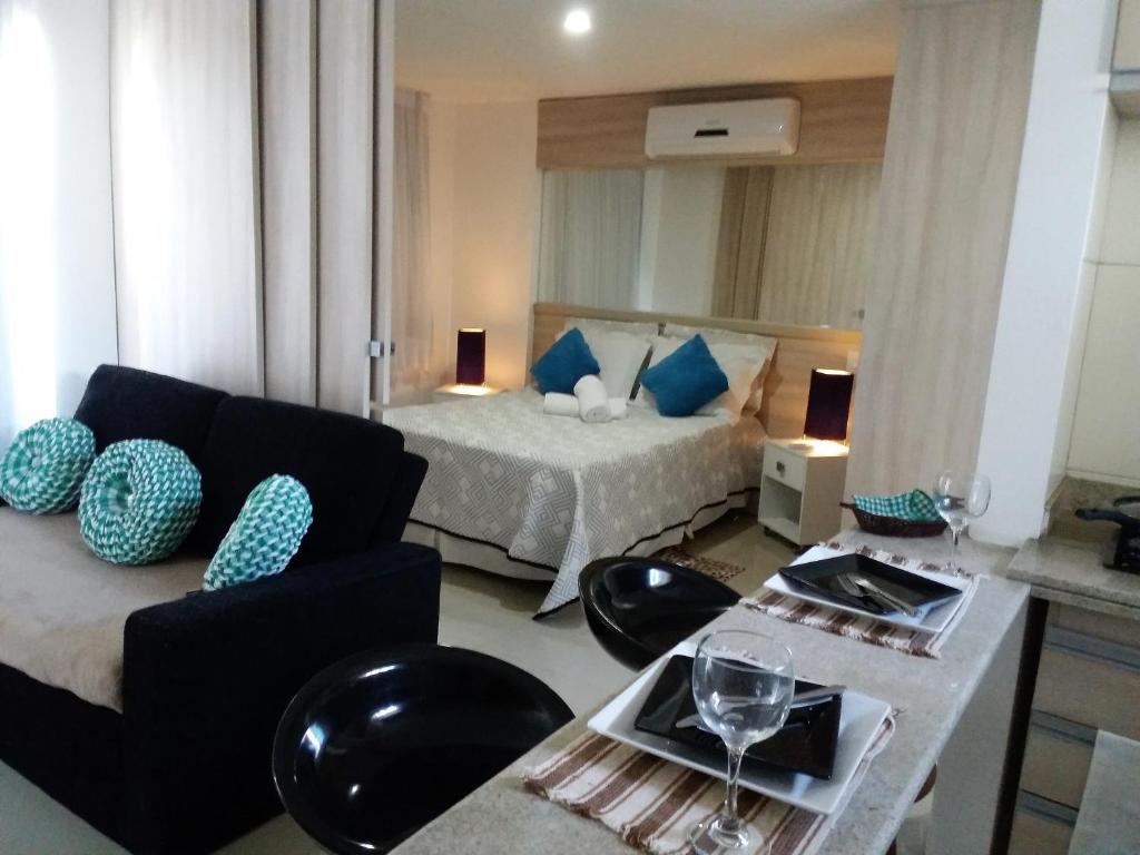 a living room with a bed and a couch at Apple Flat Natal in Natal