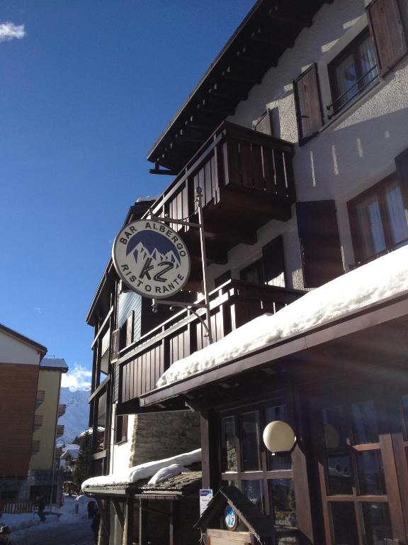 a building with a clock on the side of it at Albergo K2 in Madesimo