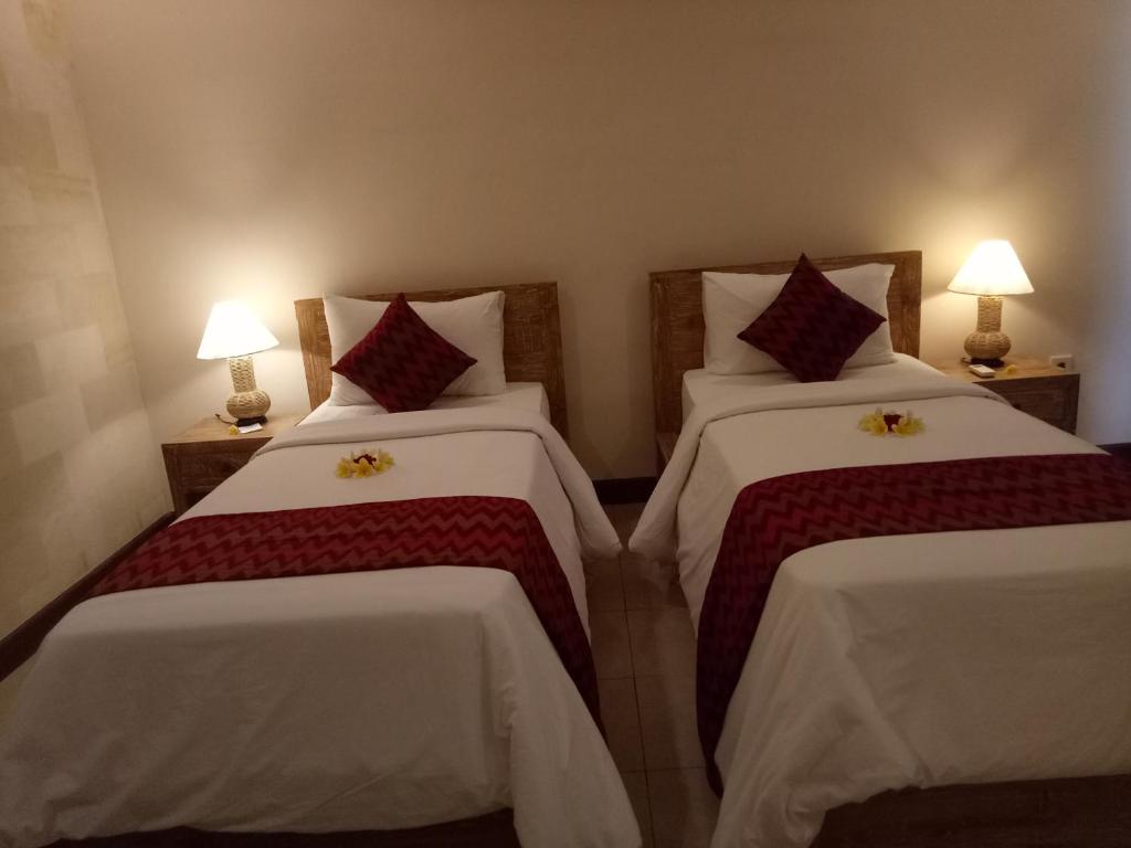 Postel nebo postele na pokoji v ubytování Umah Dajane Guest House