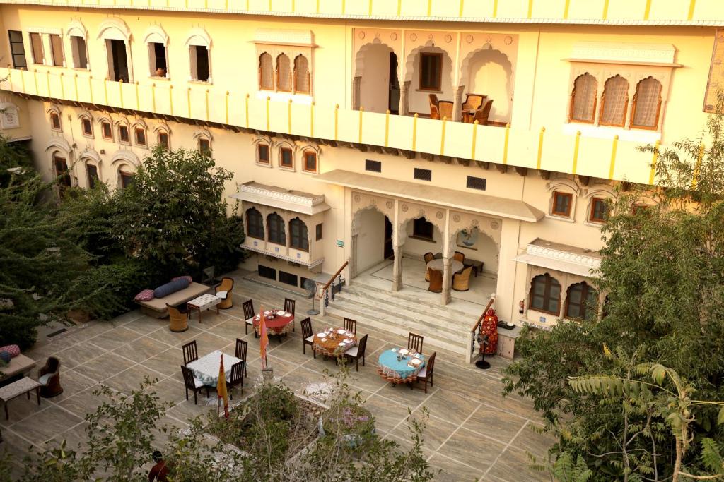 an aerial view of a building with tables and chairs at Dera Mandawa in Jaipur