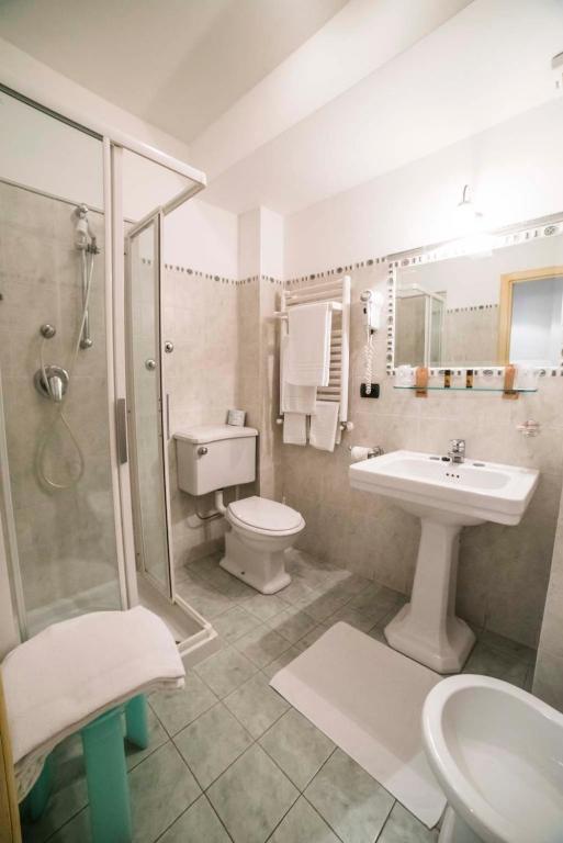 a bathroom with a sink and a toilet and a shower at Hotel Victoria in Taormina