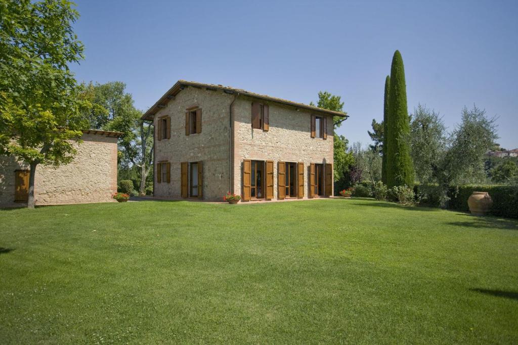 a large stone house with a large yard at Villa La Fonte in Palaia