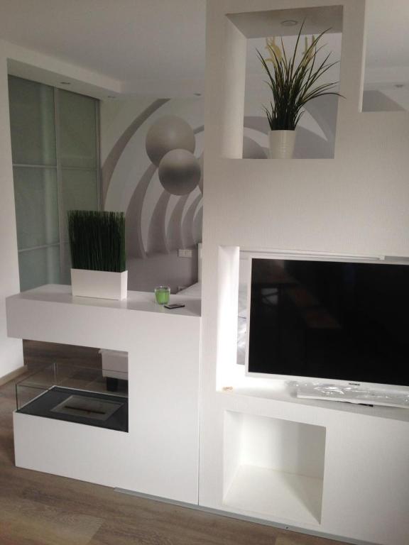 a living room with a tv and a white wall at Apartment Ferienwohnung in Sulzbach