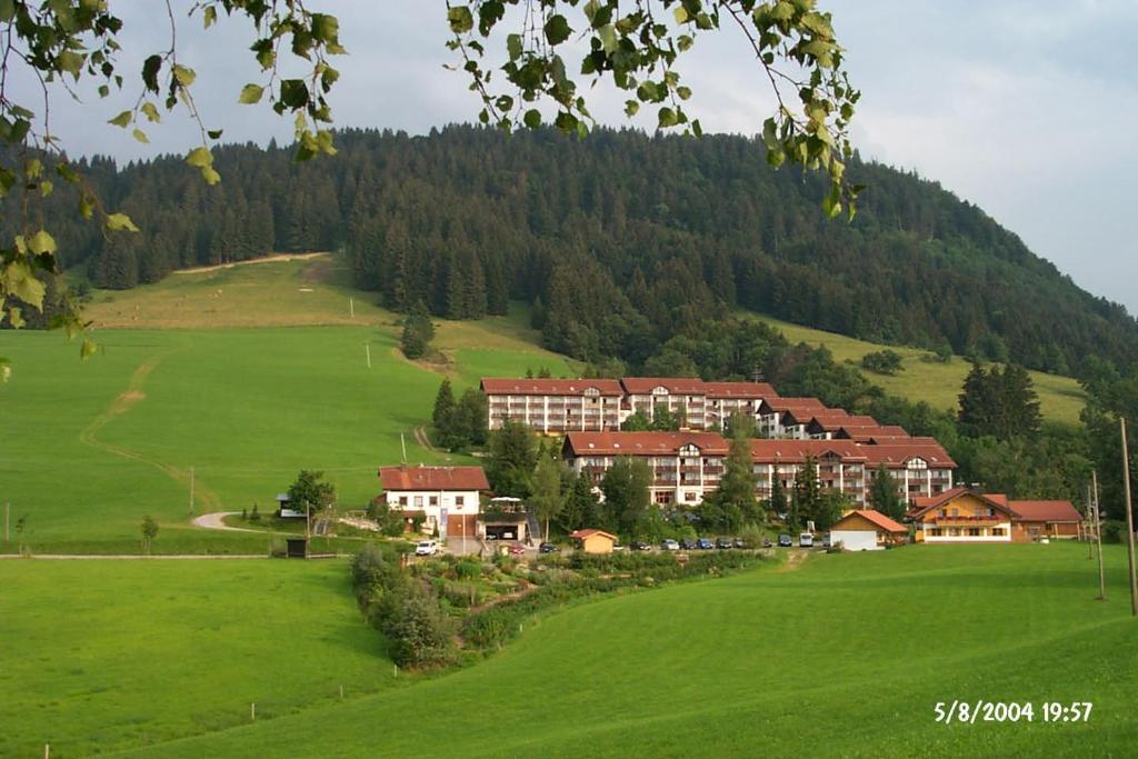 a resort in the middle of a green field at Fewo am Skihang / Bergwiese in Missen-Wilhams