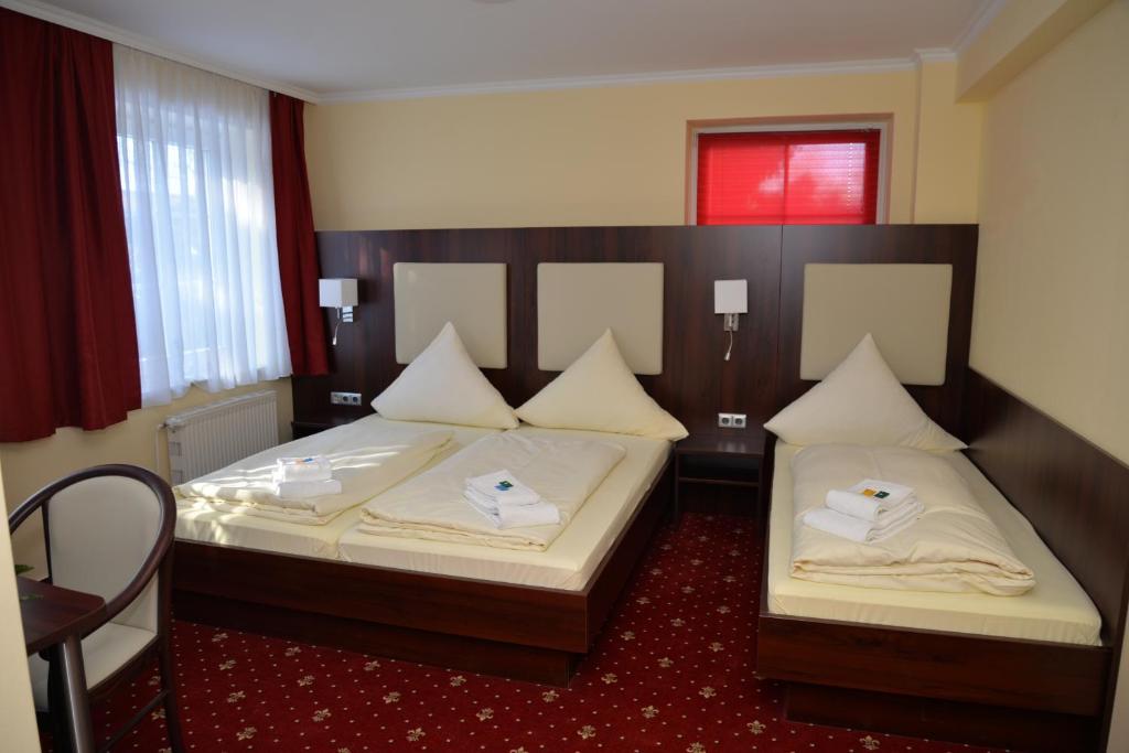 Postel nebo postele na pokoji v ubytování Hotel Neugrabener Hof