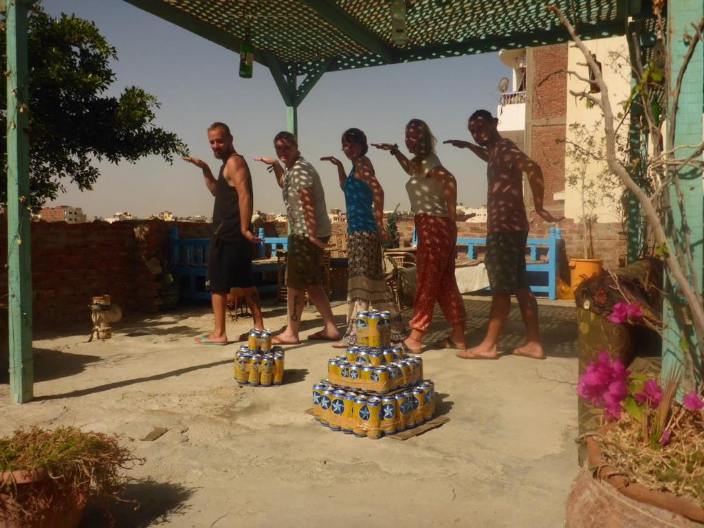 a group of people standing in front of a sculpture at Sea Waves Hostel in Hurghada