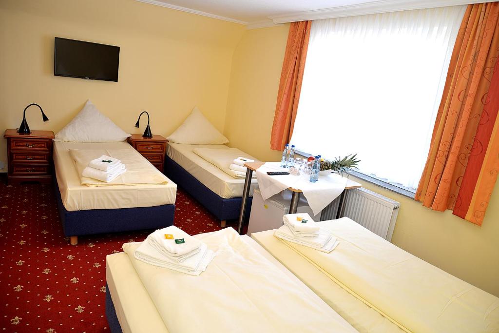 Postel nebo postele na pokoji v ubytování Hotel Neugrabener Hof