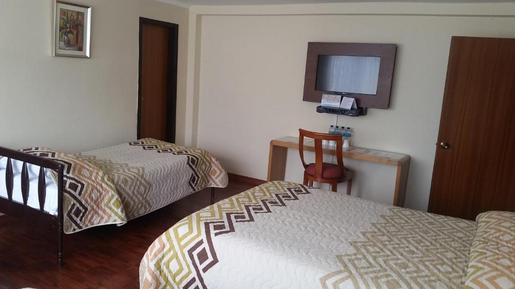 Postel nebo postele na pokoji v ubytování Hotel 6 De Diciembre