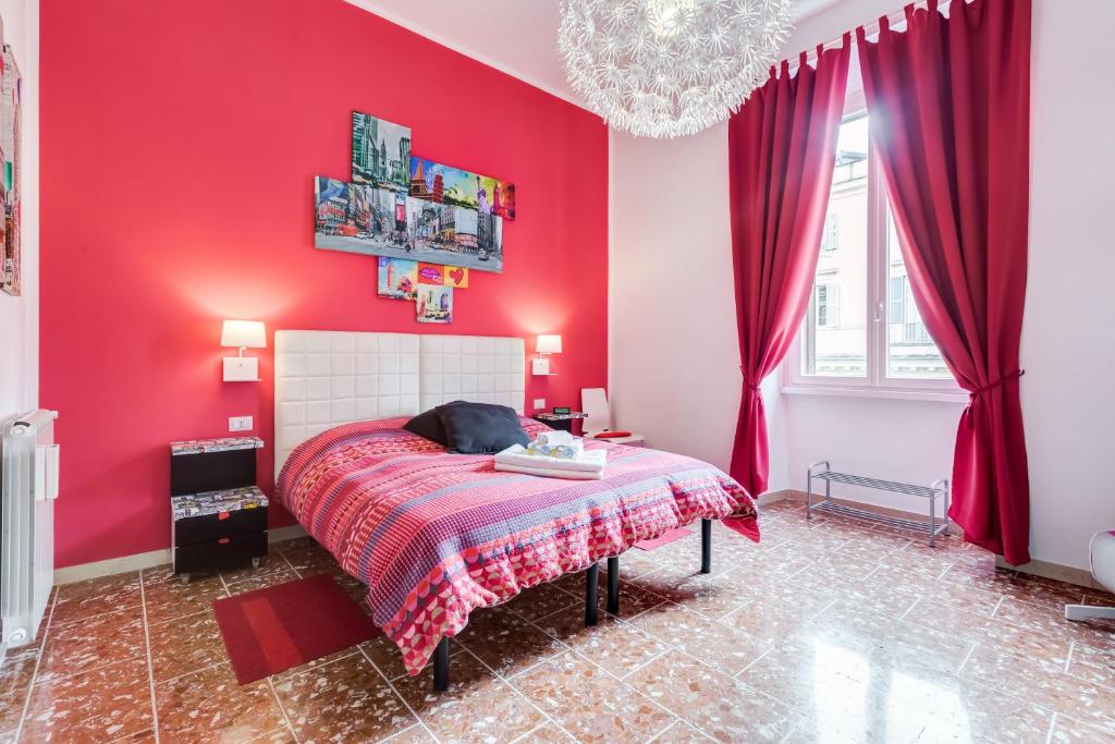 - une chambre rouge avec un lit avec un mur rouge dans l'établissement 2 Passi Al Colosseo B&B, à Rome