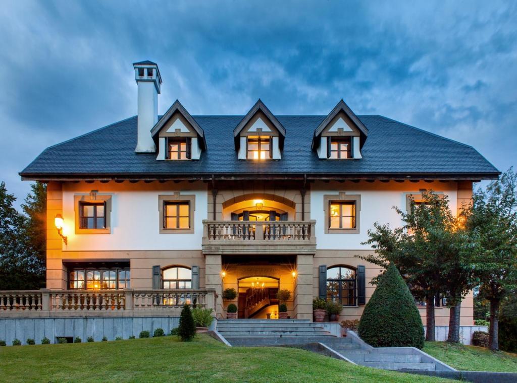a large white house with a black roof at Family Home in Oiartzun with Mountain View in Oiartzun