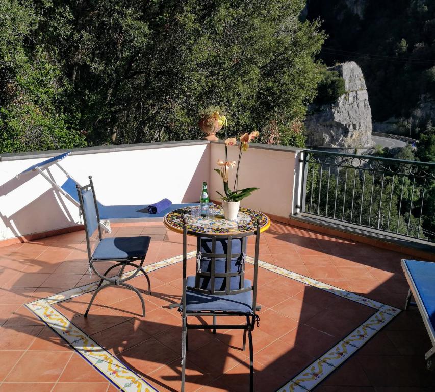 a person sitting on a bench near a patio at La Taverna del Leone in Positano