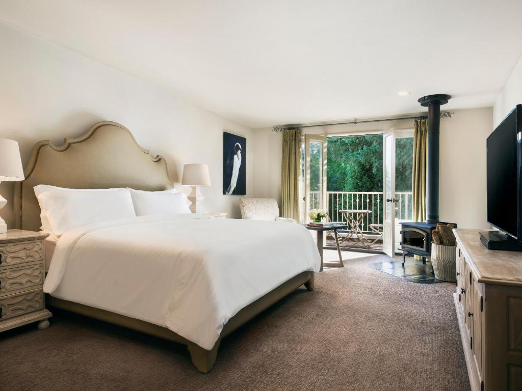 a bedroom with a large bed and a large window at Mill Valley Inn in Mill Valley