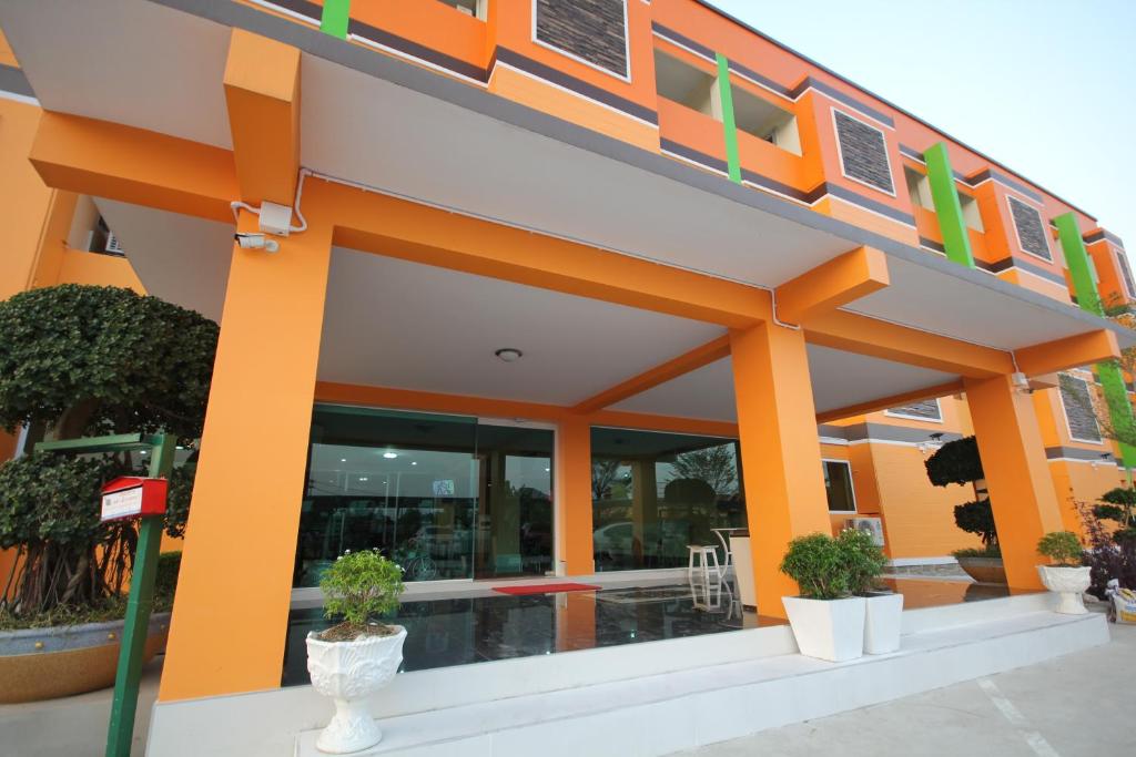 a building with orange columns and plants in front of it at Windsor Resort in Lop Buri