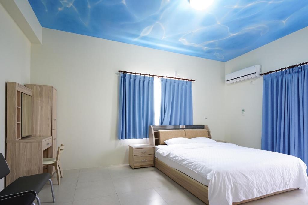 Postel nebo postele na pokoji v ubytování Penghu Sun House