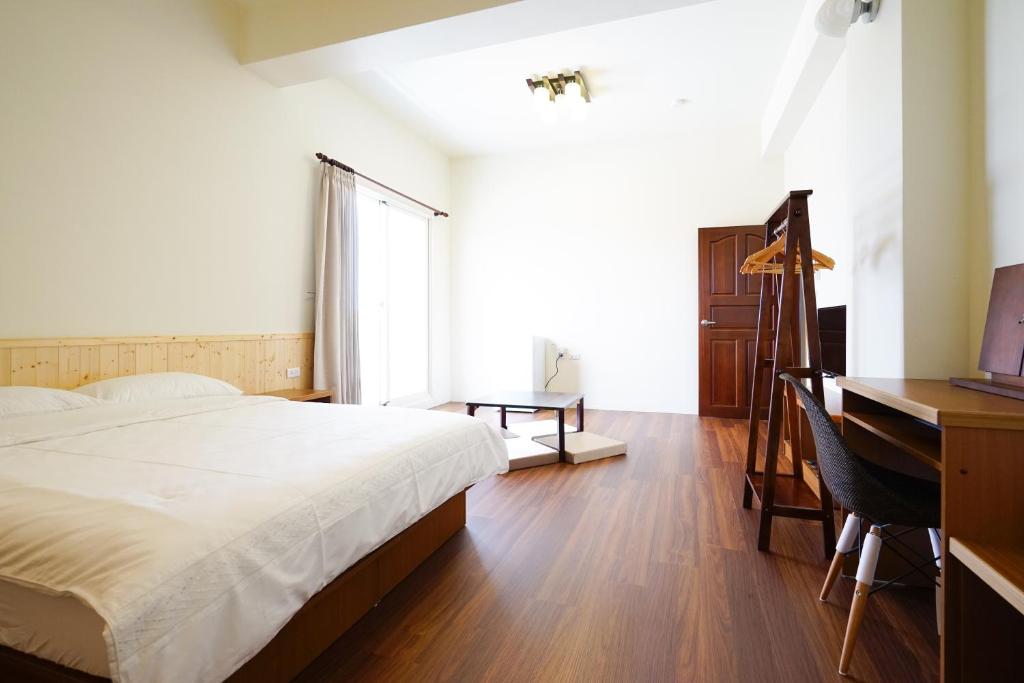Postel nebo postele na pokoji v ubytování Penghu Sun House