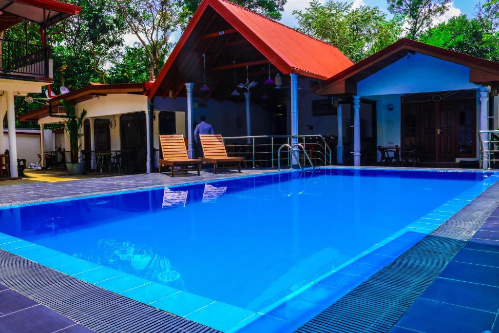 a swimming pool with a pool table in front of it at Sevonrich Holiday Resort in Dambulla