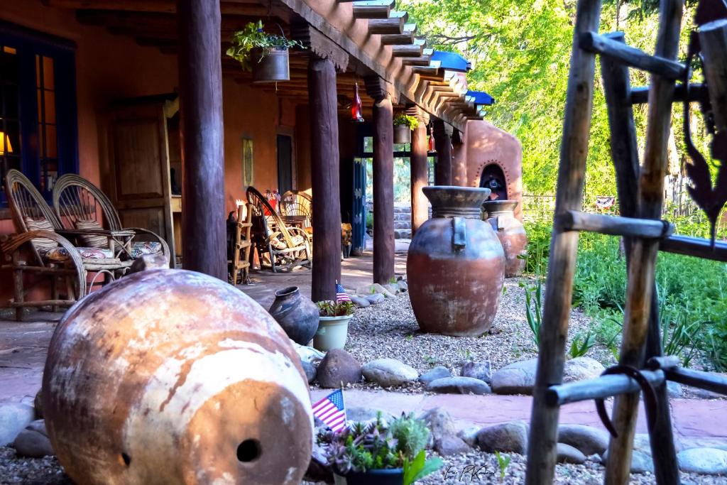 a group of large vases sitting outside of a building at Adobe and Pines Inn Bed and Breakfast in Taos