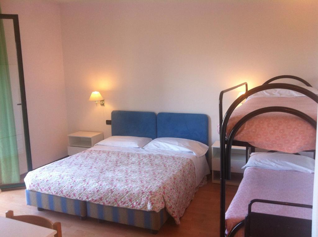 Postel nebo postele na pokoji v ubytování Hotel Angiolino