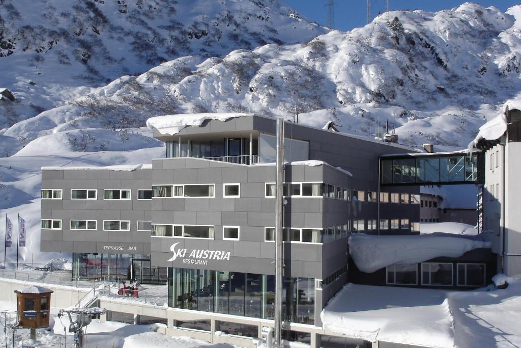 a large building with a snowboard on top of it at Hotel Ski Austria St.Christoph a.A. in Sankt Christoph am Arlberg