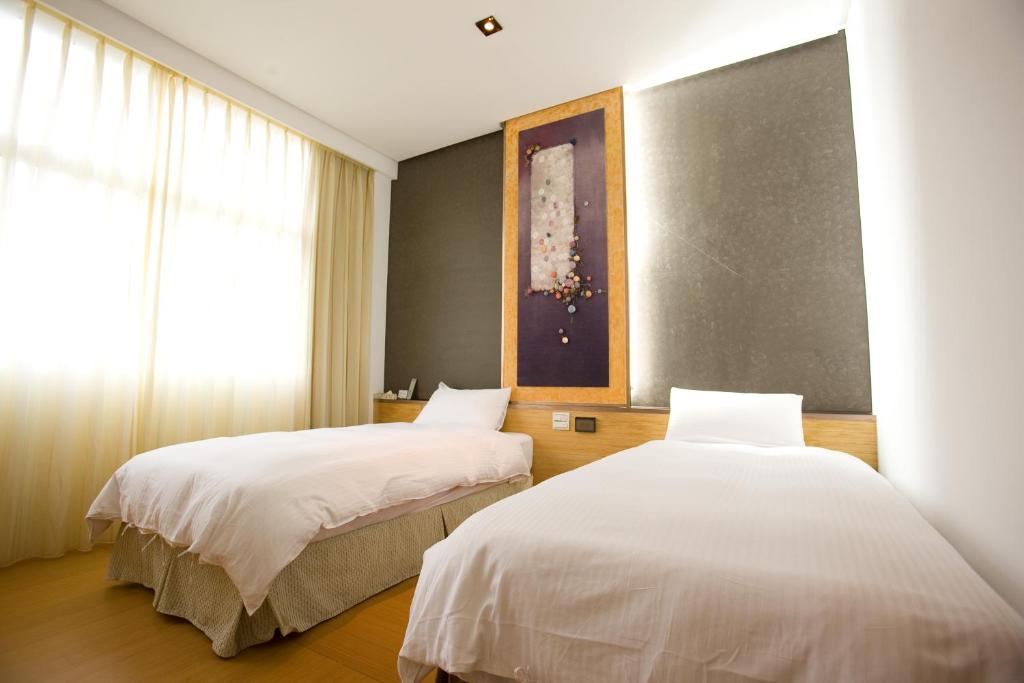 Postel nebo postele na pokoji v ubytování Zhi Da Craft Service Guest House