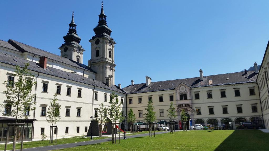 a group of buildings with a clock tower in the background at JUFA Hotel Spital am Pyhrn in Spital am Pyhrn