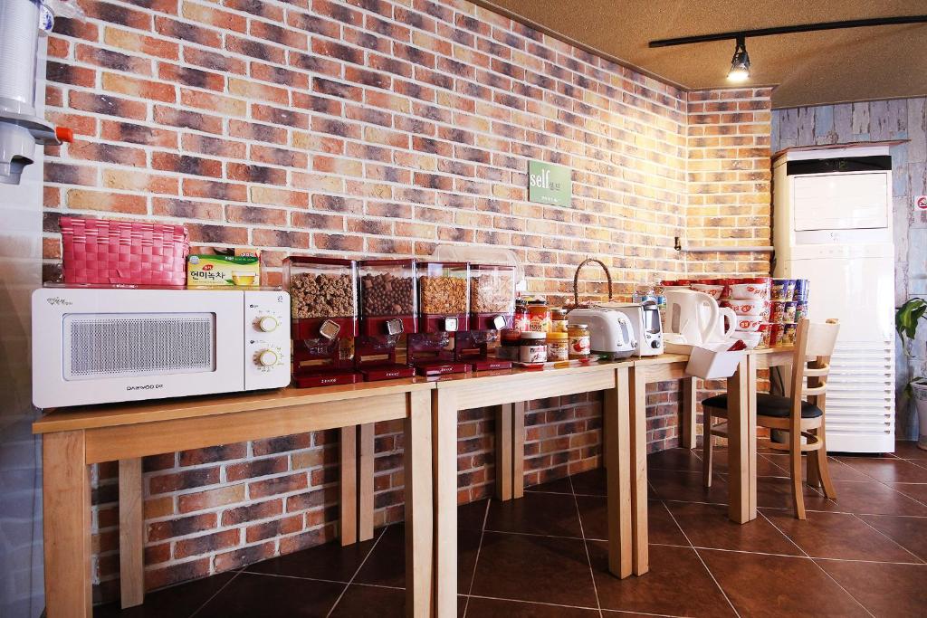 a kitchen with a counter with a microwave on it at Happy Q Motel in Andong