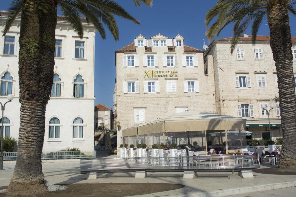 a group of people standing in front of a building at XII Century Heritage Hotel in Trogir