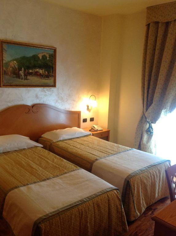 Postel nebo postele na pokoji v ubytování Hotel Camoretti