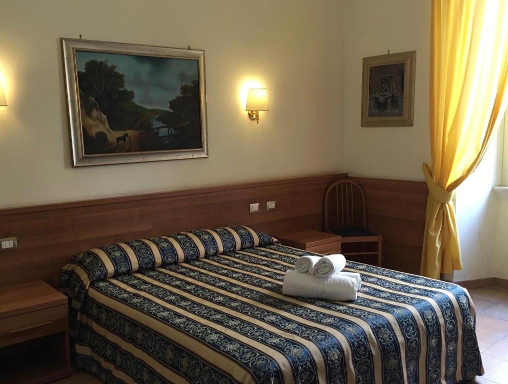 a bedroom with a bed with a stuffed animal on it at Hotel Bolognese in Rome